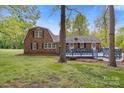 Brick home with a wooden deck and expansive backyard, perfect for outdoor living at 101 Grier St, York, SC 29745