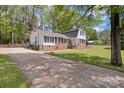 Charming brick and siding home with well-manicured lawn and mature trees at 101 Grier St, York, SC 29745