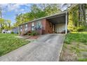 View of a red brick single-story home with a carport and a concrete driveway leading to the house at 1131 Laurel St, Salisbury, NC 28144