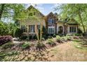 Stunning two-story home featuring a stone and stucco exterior with well-manicured landscaping at 114 Misty Meadows Ct, Mooresville, NC 28117