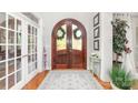 Elegant foyer with a wooden arched double door, hardwood floors, and a decorative rug at 114 Misty Meadows Ct, Mooresville, NC 28117