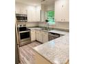 Updated kitchen features stainless steel appliances and light countertops at 11824 Larkridge Ct, Charlotte, NC 28226