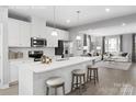 Bright, open kitchen with island, white cabinetry, and stainless steel appliances at 1344 Holden Sw Ave, Concord, NC 28025