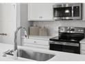 Close up of kitchen with stainless steel appliances and white subway tile backsplash at 1344 Holden Sw Ave, Concord, NC 28025