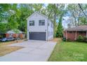 New construction home with a large, poured concrete driveway and a two car garage at 1413 Hateras Ave, Charlotte, NC 28216