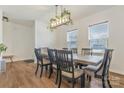 Bright dining room with a wooden table, six chairs, and stylish light fixture at 14224 Canemeadow Dr, Charlotte, NC 28278