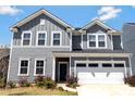 Charming two-story home with a well-maintained lawn and a two-car garage at 14224 Canemeadow Dr, Charlotte, NC 28278