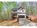 Two-story home boasts a well-manicured lawn and a two-car garage at 176 Forest Creek Dr, Statesville, NC 28625