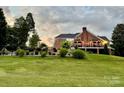 Expansive backyard with an iron fence, lush landscaping, and a charming covered patio at 1901 Benjamin Dr, Salisbury, NC 28146