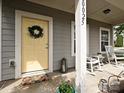 Inviting front porch featuring a charming wreath, rocking chairs, and tasteful decor at 20025 Metaphor Mews None, Davidson, NC 28036