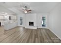 Open-concept living room with a fireplace and sleek, modern flooring at 2035 Mauney Rd, Bessemer City, NC 28016