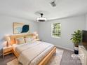 Bedroom with stylish modern decor, a window with a backyard view, and natural light at 2035 Mauney Rd, Bessemer City, NC 28016