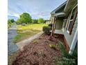 Well-manicured lawn and landscaping highlight the exterior view of this home at 213 Meadow Wind Ct, Monroe, NC 28110