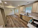 Bright, updated kitchen with new flooring, stainless steel appliances, and adjacent dining area at 213 Meadow Wind Ct, Monroe, NC 28110