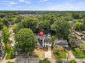 A bird's eye view of a charming neighborhood, showcasing a modern home surrounded by mature trees at 2200 Stratford Ave, Charlotte, NC 28205