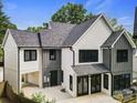 Striking exterior of a modern home with black framed windows, white and gray siding, and covered parking at 2200 Stratford Ave, Charlotte, NC 28205