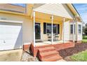 Charming one-story home features a front porch with chairs and attached one-car garage at 2703 Plantation Way, Albemarle, NC 28001