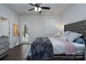 Well-lit bedroom with a bed, ceiling fan, and access to a back porch at 2932 Pirates Pl, Charlotte, NC 28216