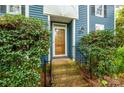 Inviting front entrance featuring a decorative door, brick steps, and manicured greenery at 3005 Kenninghall Ct, Charlotte, NC 28269