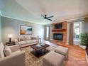 Bright living room with fireplace, hardwood floors, and large windows showcasing natural light and inviting ambiance at 3530 Farm Lake Sw Dr, Concord, NC 28027