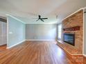 Hardwood floors accent a modern living room featuring a fireplace and ample natural lighting at 3530 Farm Lake Sw Dr, Concord, NC 28027