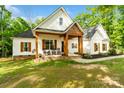 Inviting front porch with rocking chairs and wood beams, showcasing a charming entrance at 358 Grassy Ridge Ct, Clover, SC 29710