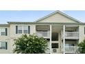 Close-up of a multi-story condo with white siding and spacious, private balconies at 3849 Carl Parmer Dr, Harrisburg, NC 28075