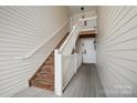 Exterior wooden staircase with white railings leading to upper-level units at 3849 Carl Parmer Dr, Harrisburg, NC 28075
