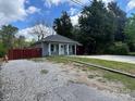 Attractive home with a covered entry, fresh gray paint, and red privacy fence at 402 California St, York, SC 29745