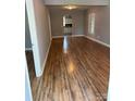 Spacious living room boasts beautiful wood-look floors, neutral paint and ample natural light at 402 California St, York, SC 29745
