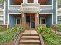 Inviting condo entrance with brick accents, covered walkways, and well-maintained landscaping at 415 Mather Green Ave # I, Charlotte, NC 28203