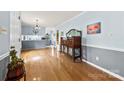 Spacious dining room featuring hardwood floors, stylish light fixture, and elegant wooden furniture at 504 Ogden Dr, Gastonia, NC 28056