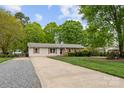 Charming one-story home boasting well-maintained landscaping and a classic, welcoming facade at 5211 Driftwood Dr, Davidson, NC 28036