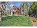 Beautiful lawn wraps this brick home with mature trees that provide shade and privacy at 528 1St Nw Ave, Hickory, NC 28601