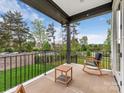 Relaxing porch with a rocking chair overlooking a beautifully landscaped front yard and quiet street at 5511 Fairview Rd, Charlotte, NC 28209