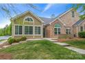 Attractive home featuring a mix of siding and stone elements, complemented by a well-maintained lawn and garden at 6311 Ridge Path Ln, Charlotte, NC 28269