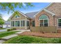 Inviting home with siding and stone details, featuring a neatly arranged landscape and clear pathway at 6311 Ridge Path Ln, Charlotte, NC 28269