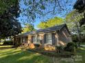 Quaint brick home with manicured landscaping, offering a serene and picturesque setting, perfect for a starter home at 729 Aintree Rd, Charlotte, NC 28215