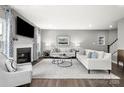 Bright living room with a fireplace, hardwood floors, and stylish furniture at 7349 Childress Sw Dr, Concord, NC 28025
