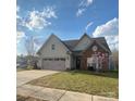 Charming home featuring a two-car garage, stone accents, and a well-manicured lawn at 740 Rosegate Dr, Gastonia, NC 28056