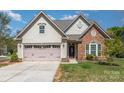 Charming home with a two-car garage, stone accents and manicured front yard at 740 Rosegate Dr, Gastonia, NC 28056