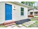 Charming home featuring a vibrant blue front door, brick steps, and stone pathway at 805 32Nd Street Ne Dr, Conover, NC 28613