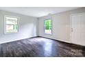 Bright living room featuring new paint, wood-look floors, and updated windows at 805 32Nd Street Ne Dr, Conover, NC 28613