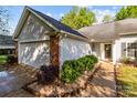 Charming single-story home features a brick and siding exterior, attached garage, and manicured landscaping at 909 Jordans Pond Ln, Charlotte, NC 28214
