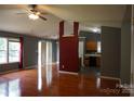 Open-concept living room with hardwood floors adjacent to the kitchen and dining areas at 9109 Foggy Meadow Rd, Charlotte, NC 28269