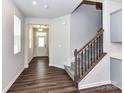 Inviting foyer with wood flooring, a staircase, and neutral paint, creating a warm entrance at 9134 Northfield Crossing Dr, Charlotte, NC 28269