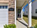 Welcoming front porch with stone accents, white pillars, and clear signage for the home's address at 9134 Northfield Crossing Dr, Charlotte, NC 28269