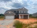 Charming two-story home with a large two-car garage and inviting front porch at 1015 Gardenia Dr # 52, Mt Ulla, NC 28125