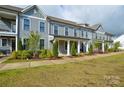 Attractive townhome exterior featuring covered entrances, tidy landscaping, and inviting curb appeal at 10209 Meeting House Nw Dr, Huntersville, NC 28078