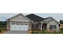 Charming single-story home with stone accents, attached garage, and well-manicured lawn at 1035 Gardenia Dr # 51, Mt Ulla, NC 28125